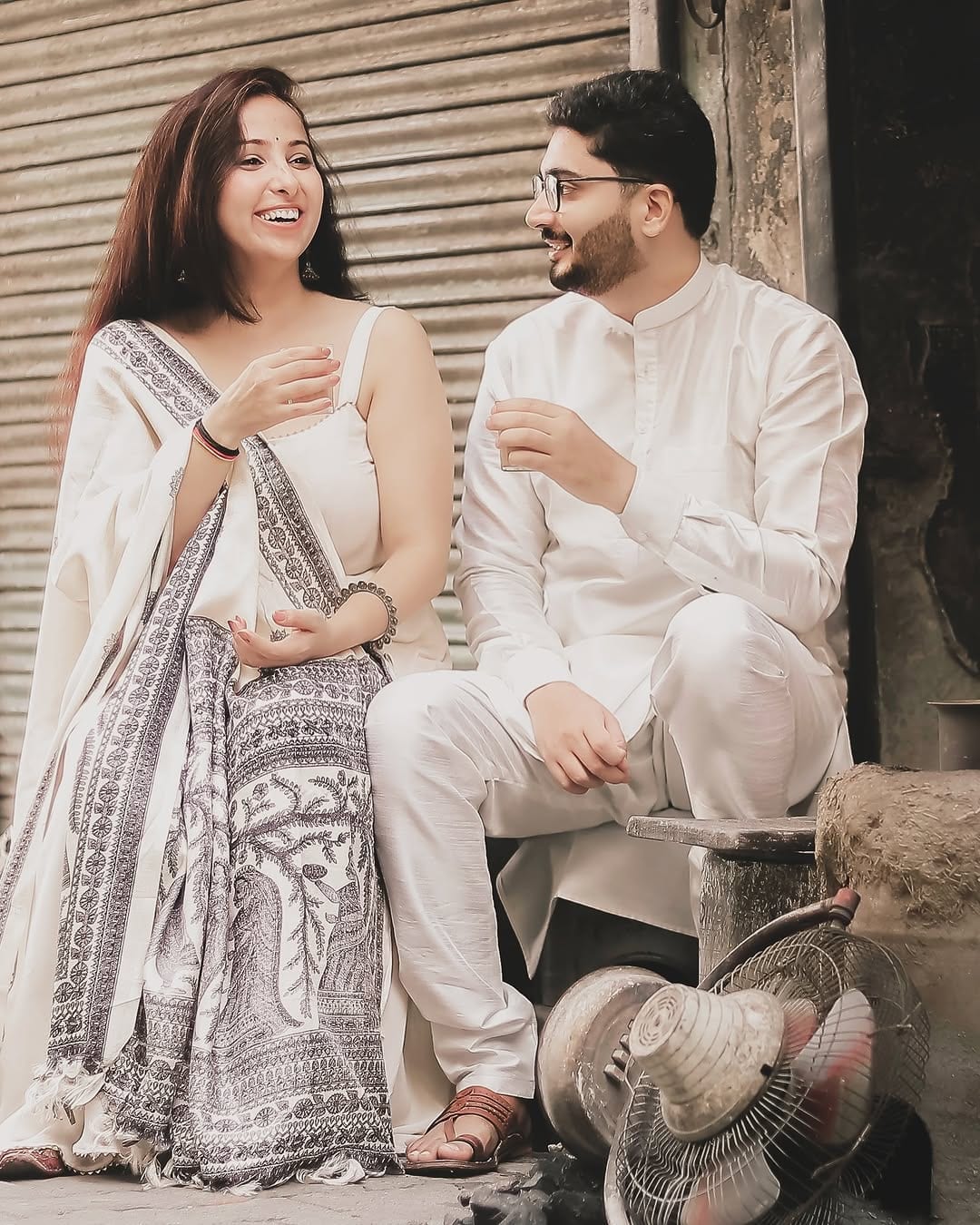 The couple close together on a quiet street