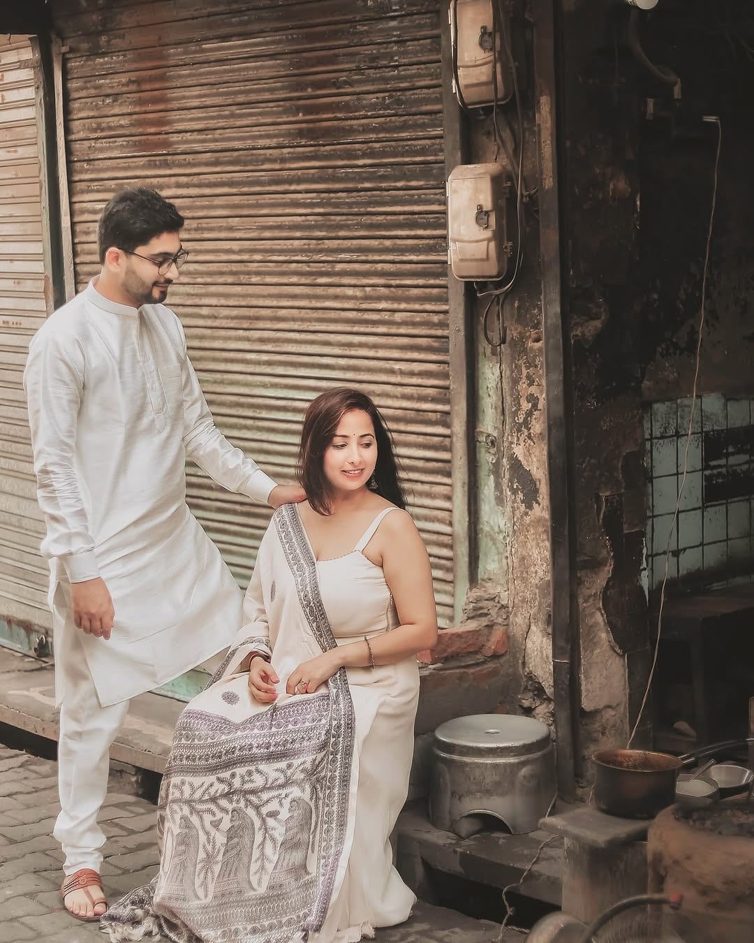 The couple standing together, white cotton and old shutters