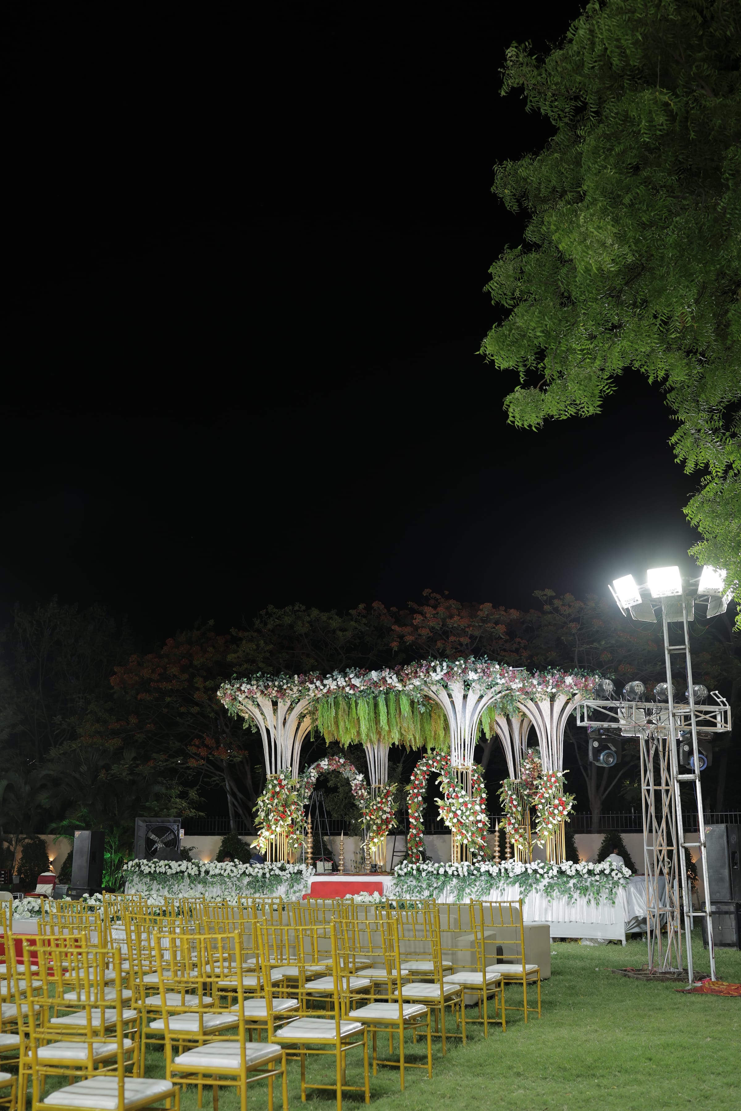 Lit installations along the garden path after dark