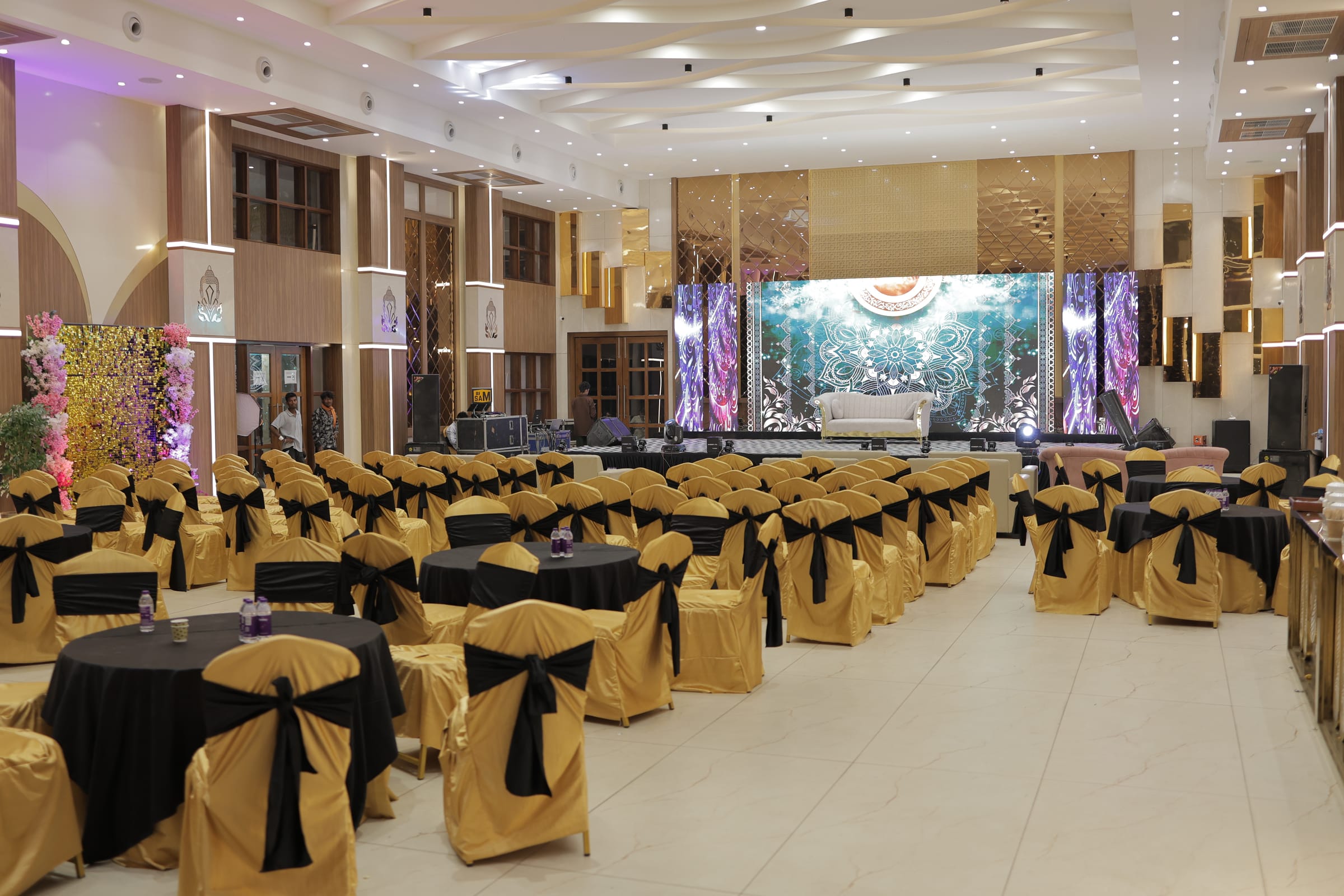 The banquet hall stage and seating, seen from the back of the room