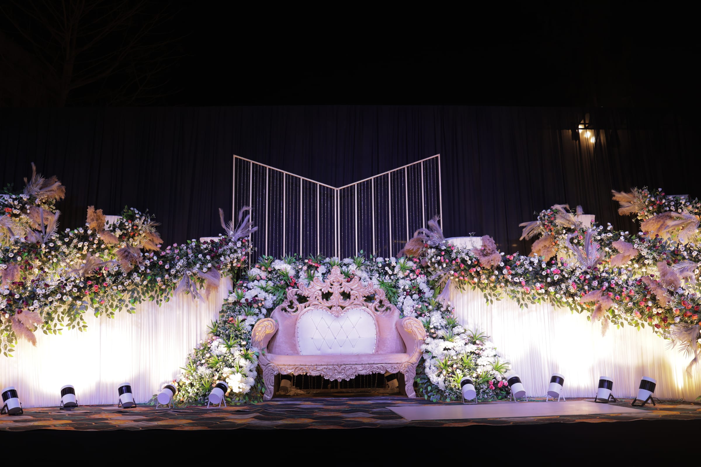 A pastel floral reception stage waiting for the couple